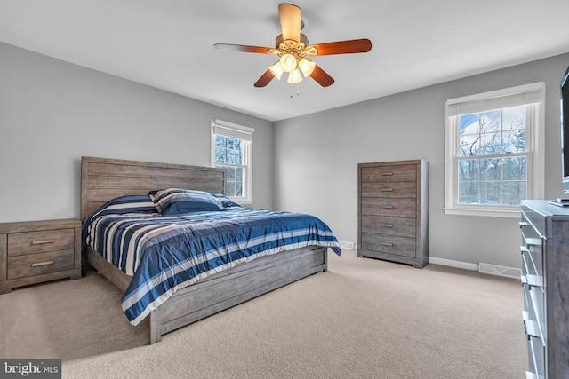 carpeted bedroom featuring baseboards and a ceiling fan