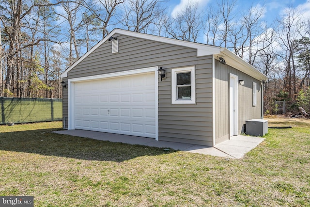 detached garage with central air condition unit and fence