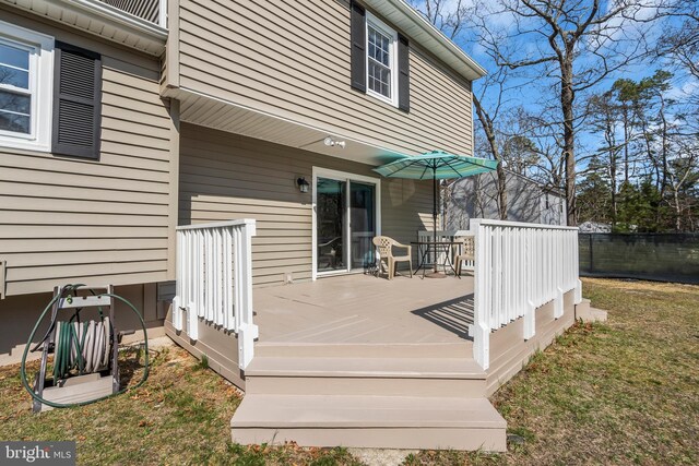 wooden terrace featuring fence