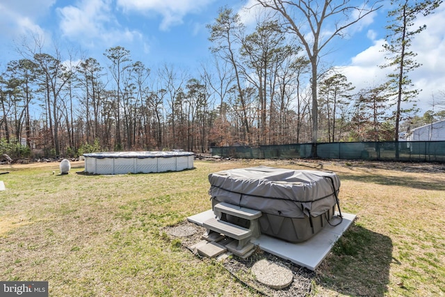 view of yard with a covered pool and fence