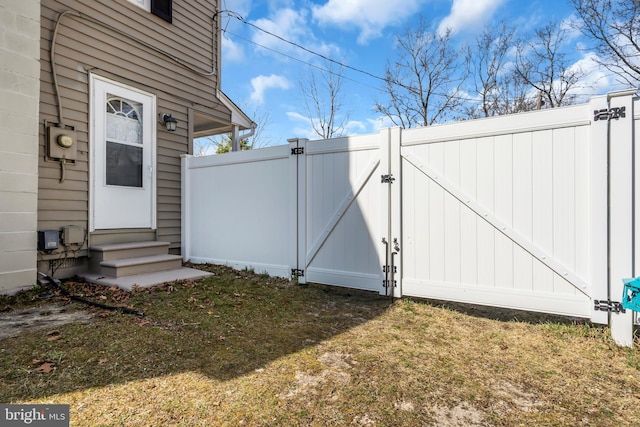exterior space with fence, a gate, and entry steps