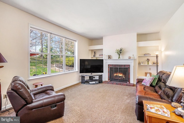 living area featuring a fireplace, carpet, baseboards, and built in features