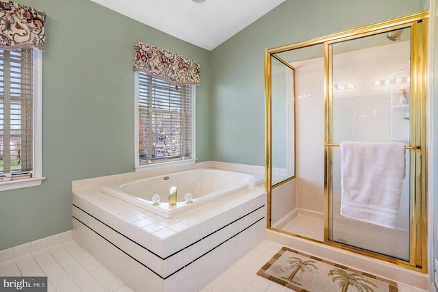 full bath featuring tile patterned floors, a stall shower, vaulted ceiling, and a garden tub