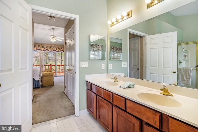 ensuite bathroom featuring a shower stall, ensuite bathroom, a sink, and a ceiling fan