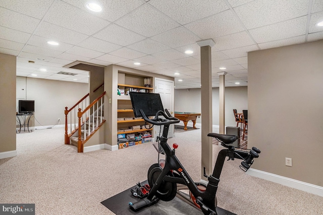 workout area featuring baseboards and carpet flooring