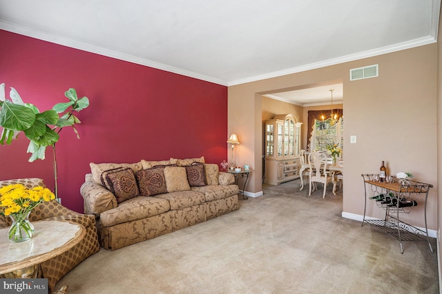 carpeted living room with a notable chandelier, visible vents, baseboards, and ornamental molding