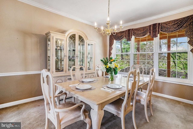 carpeted dining space with a chandelier, baseboards, and crown molding