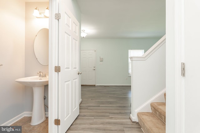 interior space featuring stairway, baseboards, and wood finished floors
