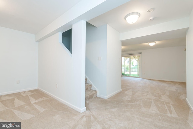 unfurnished room with baseboards, carpet flooring, and stairs