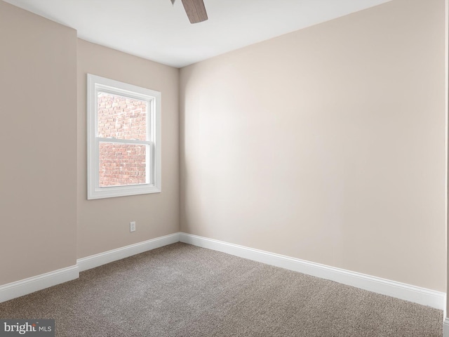 carpeted empty room with baseboards and a ceiling fan