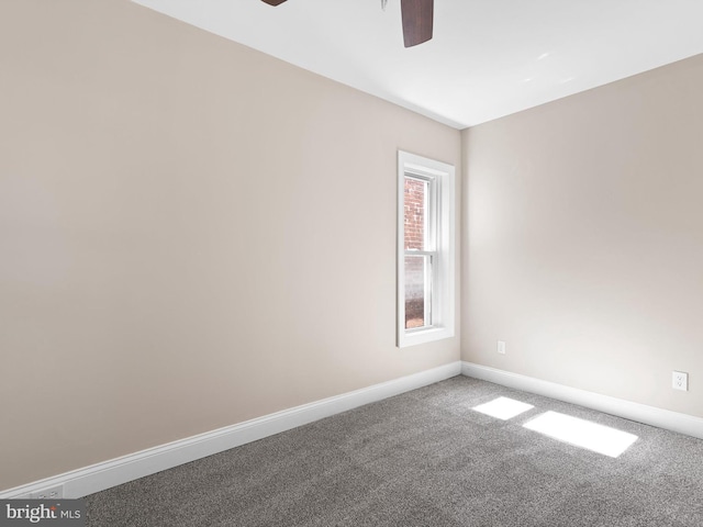 spare room featuring baseboards, carpet, and ceiling fan