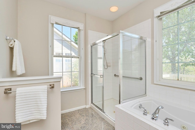 bathroom with baseboards, a garden tub, and a stall shower