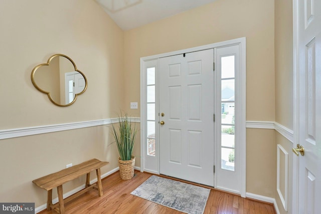 entryway with baseboards and wood finished floors