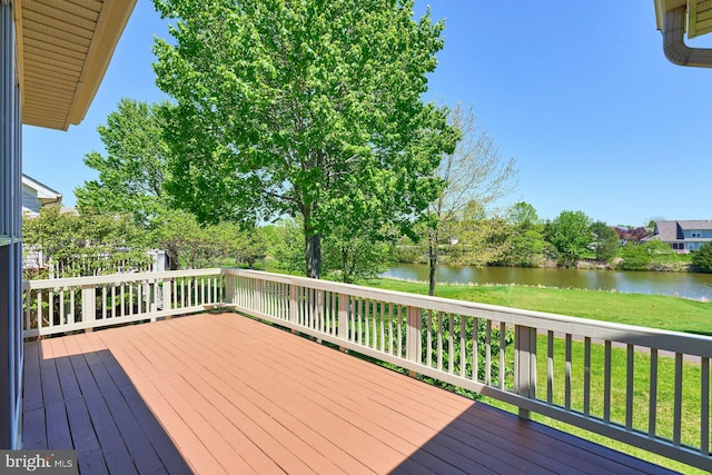 deck featuring a lawn and a water view