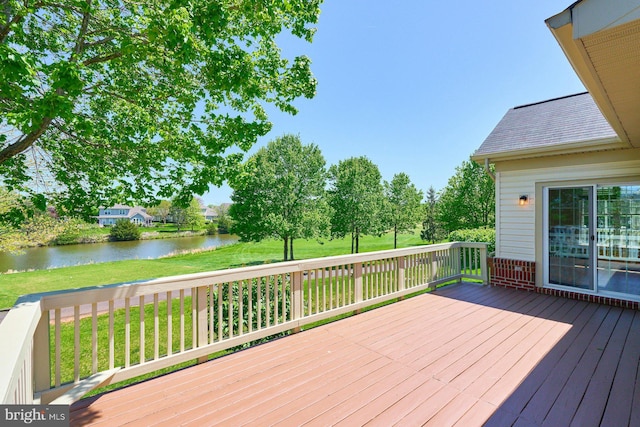 deck with a lawn and a water view