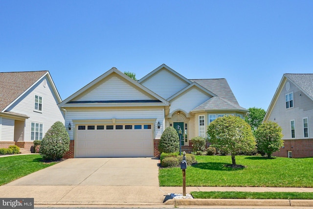view of front facade with brick siding, a garage, driveway, and a front yard