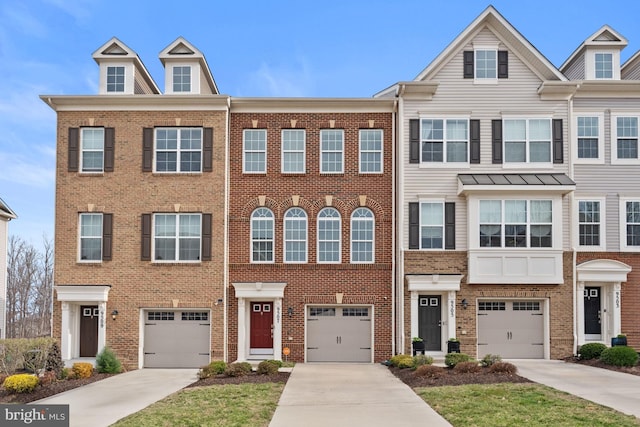townhome / multi-family property with driveway, a garage, and brick siding