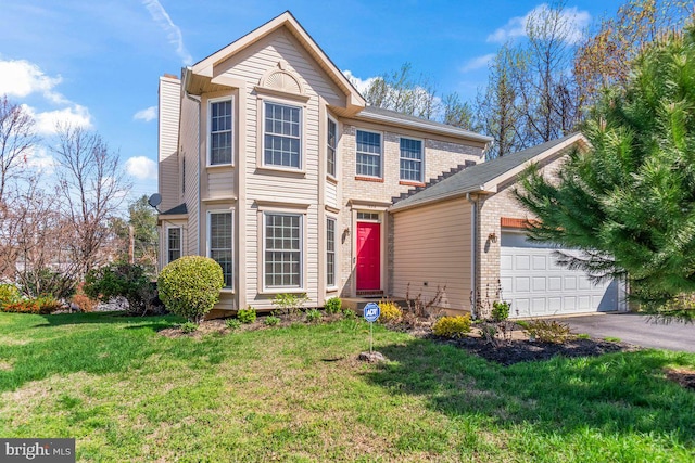 traditional home with a chimney, aphalt driveway, brick siding, a front yard, and a garage