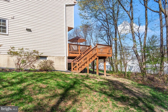 view of yard featuring a wooden deck and stairway