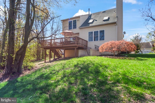 rear view of property with stairway, a deck, a chimney, and a lawn