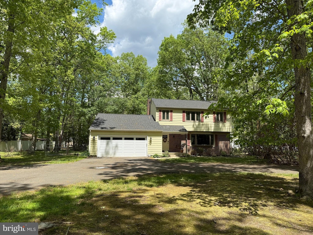 colonial-style house with driveway and a garage