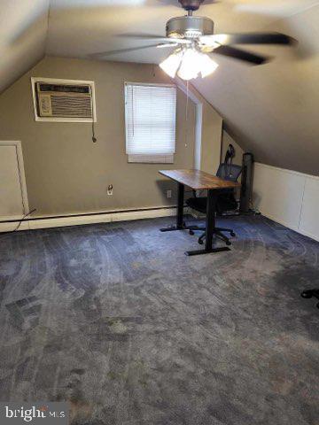 office with a baseboard heating unit, an AC wall unit, carpet, lofted ceiling, and a ceiling fan