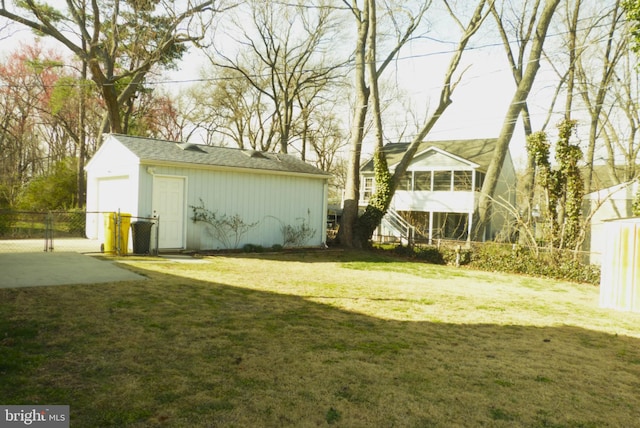 view of yard with a gate, an outdoor structure, and fence