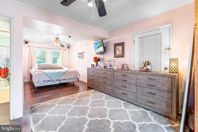 bedroom with wood finished floors, a ceiling fan, and baseboards