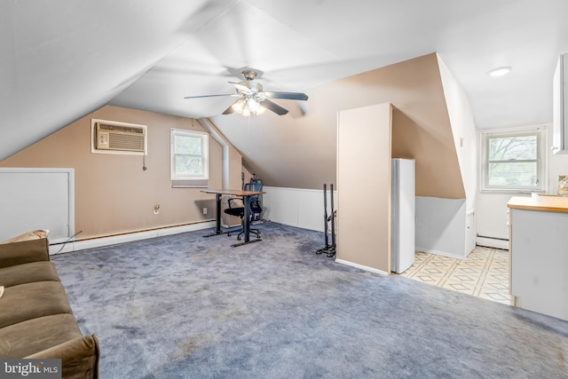 carpeted office space featuring baseboard heating, lofted ceiling, a ceiling fan, and a wall mounted air conditioner