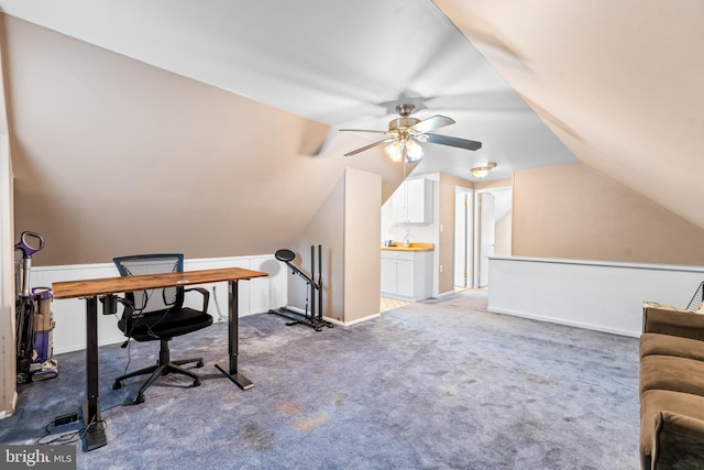office space featuring ceiling fan, carpet floors, lofted ceiling, and baseboards