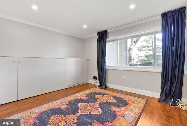 unfurnished room with baseboards, wood finished floors, recessed lighting, and ornamental molding