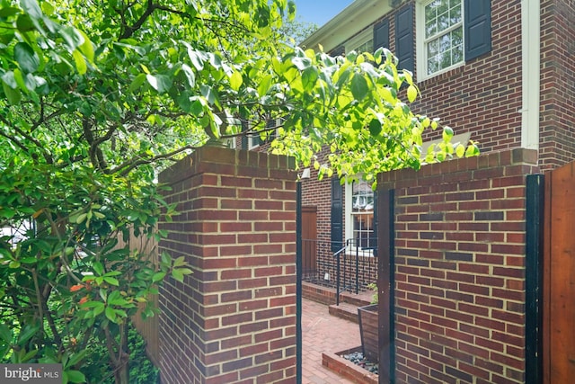 view of property exterior with brick siding