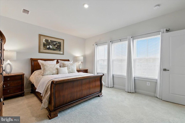 bedroom featuring light carpet, baseboards, and visible vents
