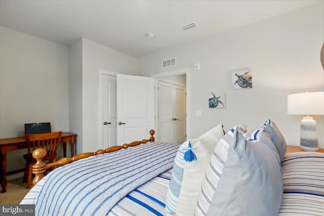 carpeted bedroom featuring visible vents