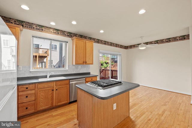 13604 Red Squirrel Way, Herndon, VA 20171 - kitchen with appliances with stainless steel finishes, a sink, dark countertops, backsplash, and light wood-style flooring