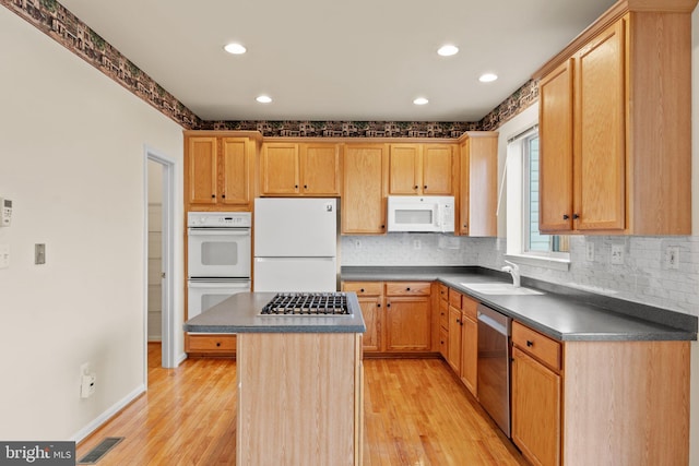 13604 Red Squirrel Way, Herndon, VA 20171 - kitchen with appliances with stainless steel finishes, a sink, dark countertops, light wood-style floors, and recessed lighting