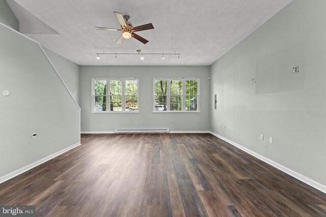 unfurnished living room with track lighting, wood finished floors, baseboards, ceiling fan, and baseboard heating