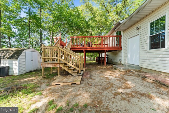 exterior space featuring stairs, a deck, an outbuilding, and a shed