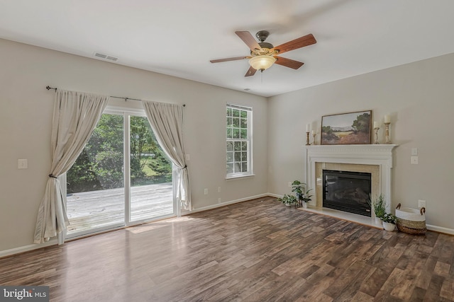 11587 Wollaston Cir, Swan Point, MD 20645 - unfurnished living room with wood finished floors, ceiling fan, a glass covered fireplace, and baseboards