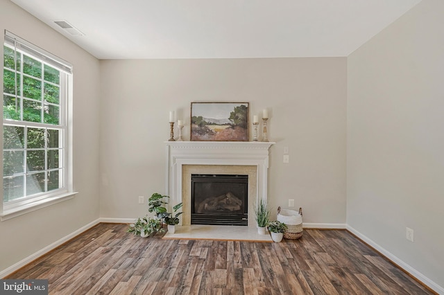 11587 Wollaston Cir, Swan Point, MD 20645 - unfurnished living room featuring wood finished floors, a glass covered fireplace, and baseboards