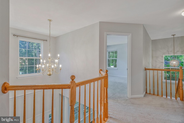 11587 Wollaston Cir, Swan Point, MD 20645 - corridor with a chandelier, an upstairs landing, healthy amount of natural light, and carpet