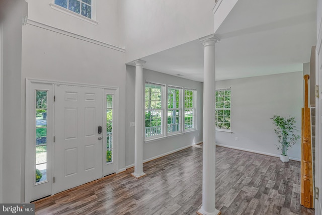 11587 Wollaston Cir, Swan Point, MD 20645 - entrance foyer featuring decorative columns, wood finished floors, baseboards, and a towering ceiling