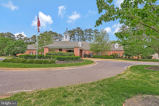 11587 Wollaston Cir, Swan Point, MD 20645 - view of front facade featuring asphalt driveway, brick siding, a front yard, and a garage