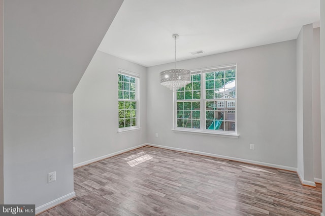 11587 Wollaston Cir, Swan Point, MD 20645 - unfurnished dining area with wood finished floors, baseboards, and a chandelier