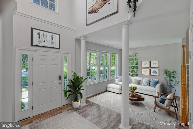 11587 Wollaston Cir, Swan Point, MD 20645 - foyer entrance with ornate columns, wood finished floors, a high ceiling, and baseboards