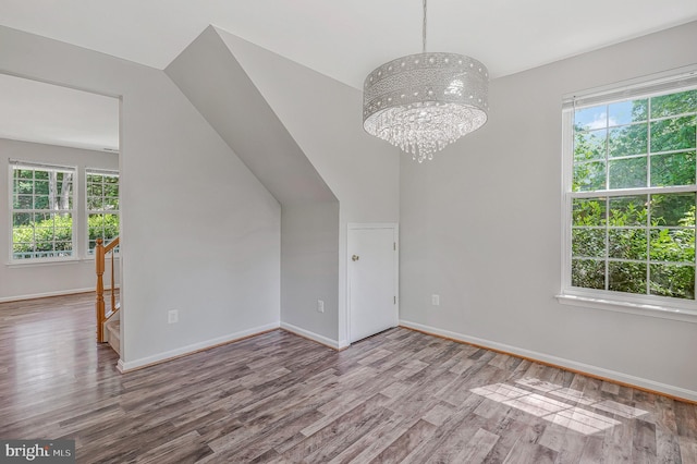 11587 Wollaston Cir, Swan Point, MD 20645 - empty room with wood finished floors, a chandelier, and baseboards