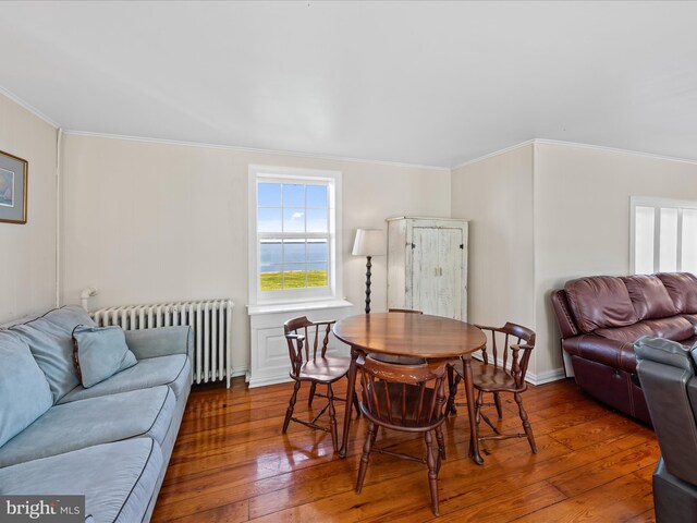 5917 Horns Point Rd, Cambridge, MD 21613 - dining area with ornamental molding, radiator heating unit, and hardwood / wood-style flooring