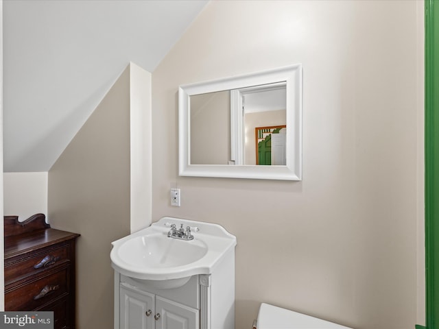 5917 Horns Point Rd, Cambridge, MD 21613 - bathroom with lofted ceiling, toilet, and vanity