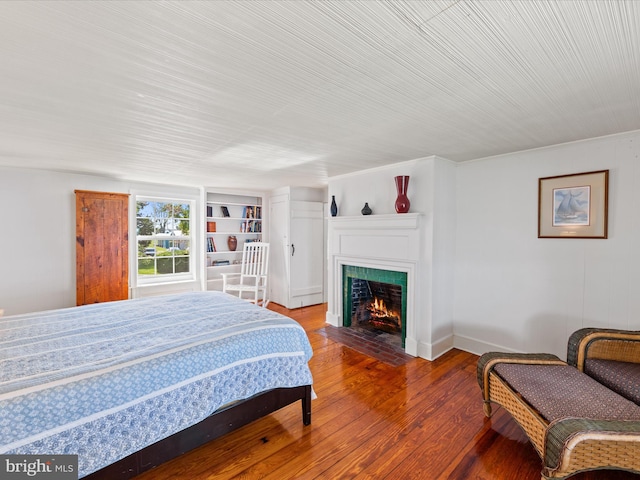 5917 Horns Point Rd, Cambridge, MD 21613 - bedroom with a fireplace with flush hearth, hardwood / wood-style floors, and baseboards