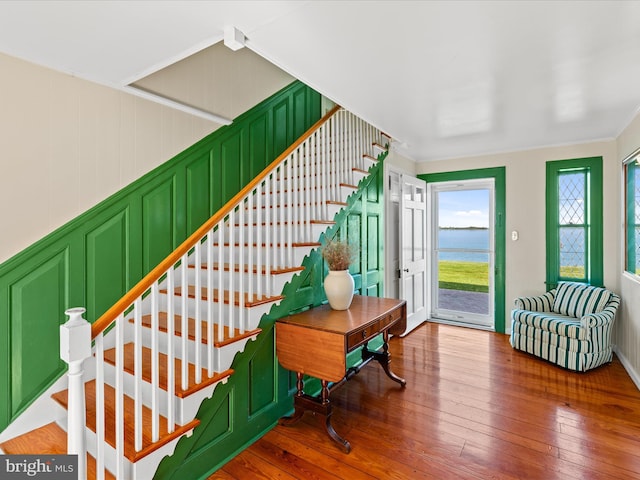5917 Horns Point Rd, Cambridge, MD 21613 - stairs featuring hardwood / wood-style flooring, a water view, ornamental molding, and a decorative wall